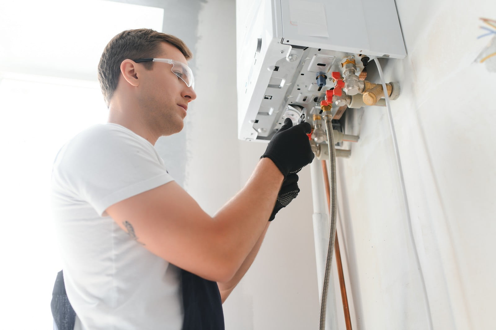 I'm unable to view images directly, but I can help you understand how to describe an image effectively. Based on the URL you provided, which includes words like "professional plumber checking a boiler and pipes," here is how you might describe the content of the image:---In the image, there is a professional plumber diligently inspecting a boiler and its associated piping. The plumber is dressed in standard work attire, possibly including overalls and safety gear such as gloves and maybe a helmet, depending on the workplace safety requirements. The boiler and pipes are likely located in a utility room or basement, and there may be various tools and instruments either in the plumber’s hands or nearby to aid in the inspection. The scene conveys a sense of professionalism and expertise as the plumber ensures the proper functioning and safety of the heating system.---Feel free to provide more details or correct any assumptions if needed!